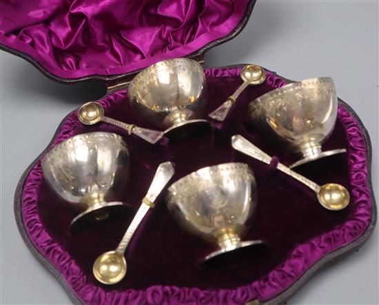 A cased set of 4 Victorian engraved silver salts and four spoons, London, 1882.